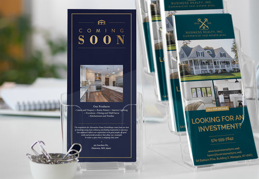 Real estate brochures on a table with a focus on 'Coming Soon' and investment opportunities.